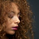 Beauty portrait of a beautiful young woman with curly hair